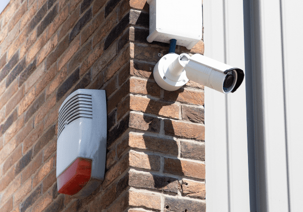 CCTV Security camera at building in city on brick wall