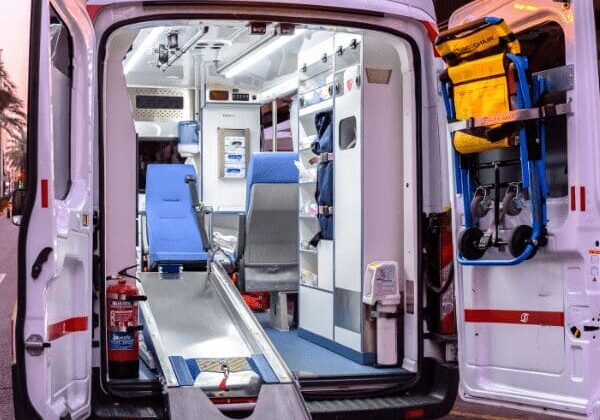 An ambulance with an open door and medical equipment inside, ready to provide emergency medical assistance.